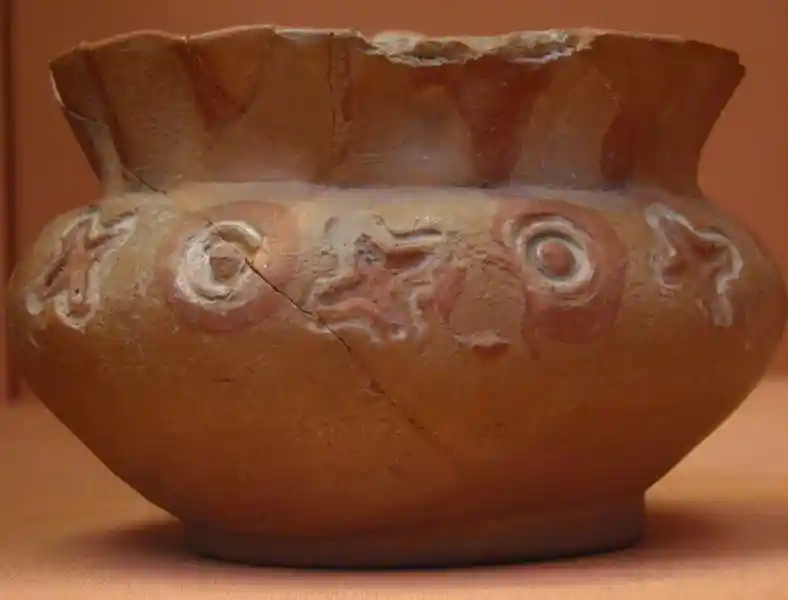 Cross and circles on a crinkled vase